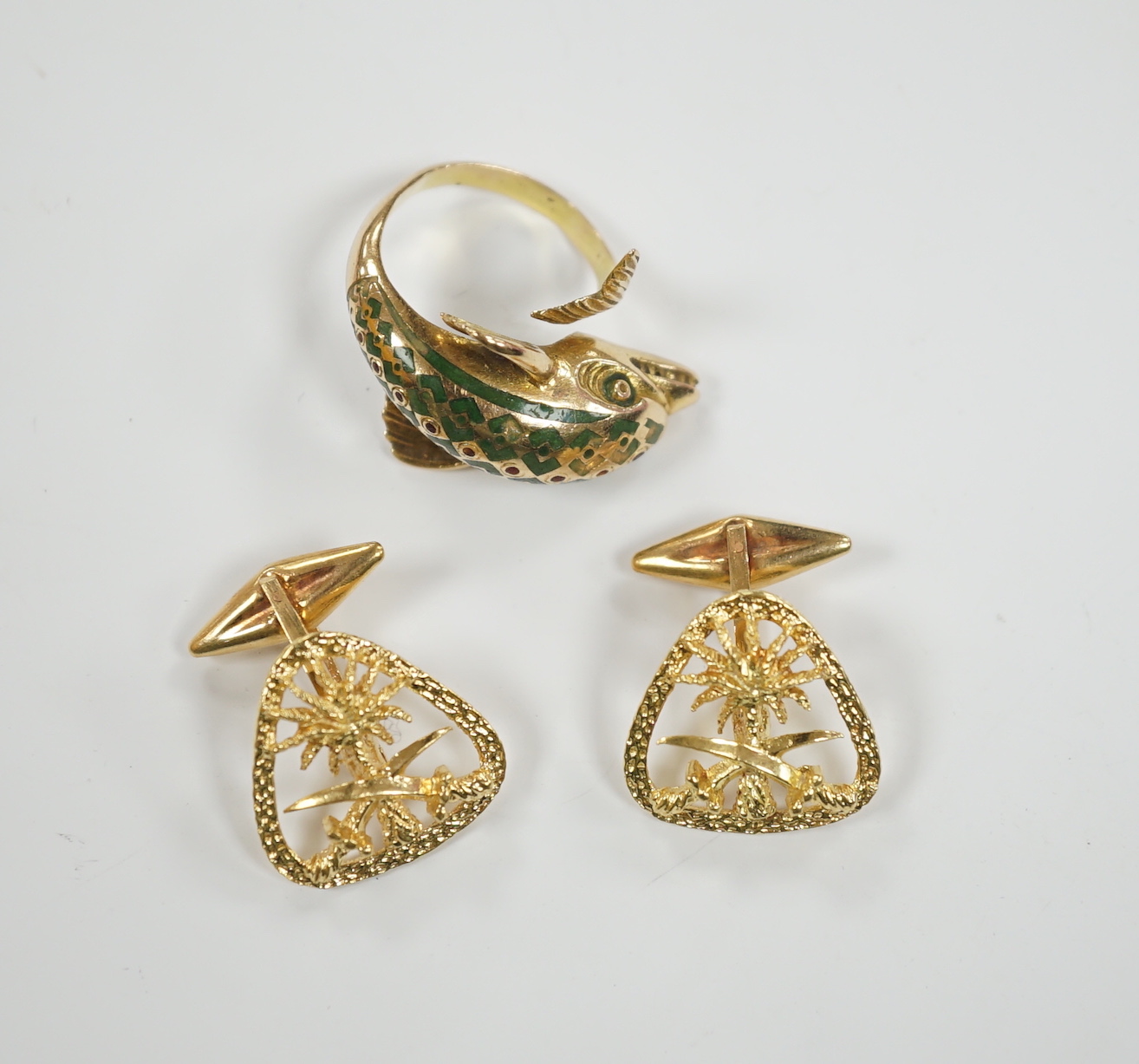 A continental 18k and two colour enamel dolphin ring, size N and a pair of 750 yellow metal Middle Eastern cufflinks